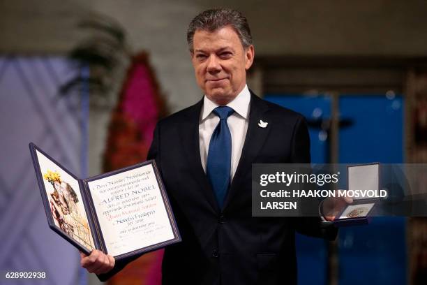 Nobel Peace Prize laureate Colombian President Juan Manuel Santos poses with the medal and diploma during the award ceremony of the Nobel Peace Prize...