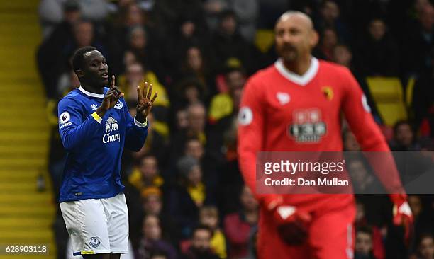 Heurelho Gomes of Watford looks dejected as Romelu Lukaku of Everton celebrates as he scores the first goal during the Premier League match between...
