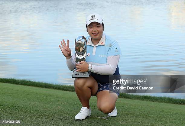 Shangshan Feng of China holds the trophy after her round of 64 had secured her victory during the final round of the 2016 Omega Dubai Ladies Masters...