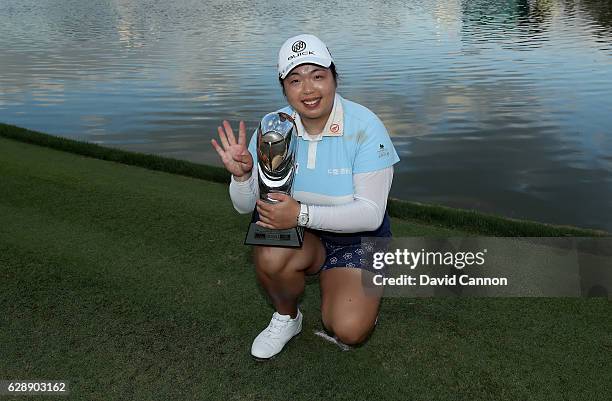 Shangshan Feng of China holds the trophy after her round of 64 had secured her victory during the final round of the 2016 Omega Dubai Ladies Masters...