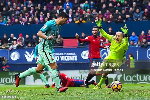 Luis Suarez of FC Barcelona scores the opening goal during the La Liga match between CA Osasuna and FC Barcelona at Sadar stadium on December 10,...