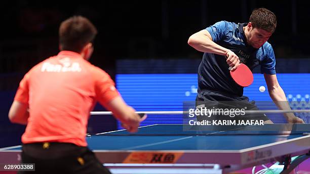 Dimitrij Ovtcharov of Germany plays a shot during his men's single quarter-final table tennis match against Fan Zhendong of China at the Qatar 2016...