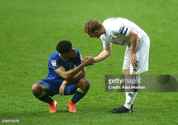 Lyle Taylor of AFC Wimbledon and Dean Lewington of MK Dons shake hands after the final whistle during the Sky Bet League One match between Milton...
