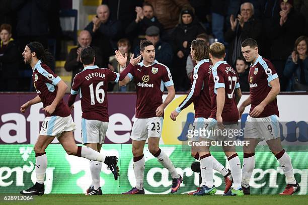 Burnley's Irish defender Stephen Ward celebrates with teammates after scoring their second goal during the English Premier League football match...