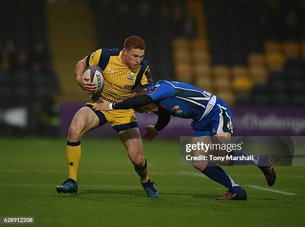 Connor Braid of Worcester Warriors is tackled by Sarel Pretorius of Newport Gwent Dragons during the European Rugby Challenge Cup match between...