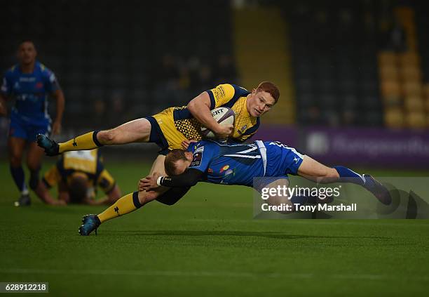 Connor Braid of Worcester Warriors is tackled by Sarel Pretorius of Newport Gwent Dragons during the European Rugby Challenge Cup match between...