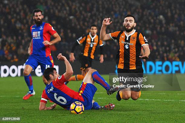 Scott Dann of Crystal Palace challenges Robert Snodgrass of Hull City to concede a penalty during the Premier League match between Hull City and...