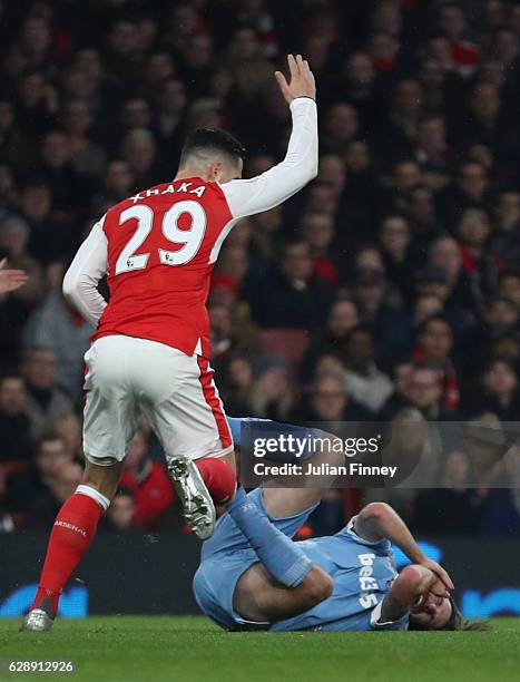 Granit Xhaka of Arsenal reacts to Joe Allen of Stoke City going down after being challenged by Shkodran Mustafi of Arsenal during the Premier League...