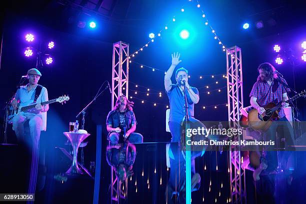 Recording artists Jon Jones, Chris Thompson, Mike Eli, and James Young of Eli Young Band perform onstage during CMT Story Behind The Songs LIV +...