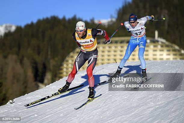 Winner Norway's Martin Johnsrud Sundby competes ahead of third placed Matti Heikkinen during the Men's 30km individual free race at the FIS Cross...