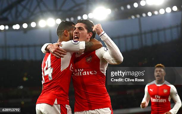 Theo Walcott of Arsenal celebrates scoring his sides first goal with Hector Bellerin of Arsenal during the Premier League match between Arsenal and...