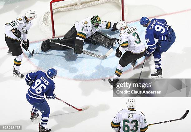 Spencer Watson of the Mississauga Steelheads gets set to pounce on a puck to score a goal against Tyler Parsons of the London Knights during an OHL...