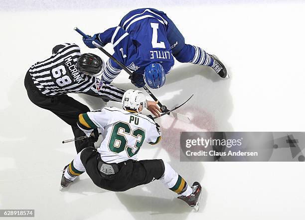 Michael Little of the Mississauga Steelheads takes a faceoff against Cliff Pu of the London Knights during an OHL game at Budweiser Gardens on...