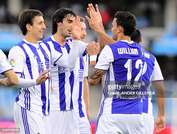 Real Sociedad's Brazilian forward Willian Jose is congratulated by teammates after scoring his team's second goal during the Spanish league football...
