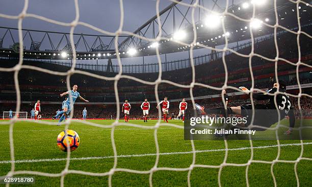 Joe Allen of Stoke City scores his sides first goal from the penalty spot beating Petr Cech of Arsenal during the Premier League match between...