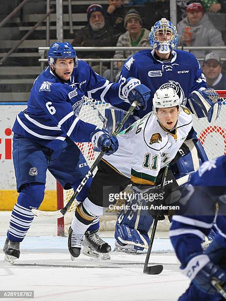 Stephen Gibson of the Mississauga Steelheads battles against Owen MacDonald of the London Knights during an OHL game at Budweiser Gardens on December...