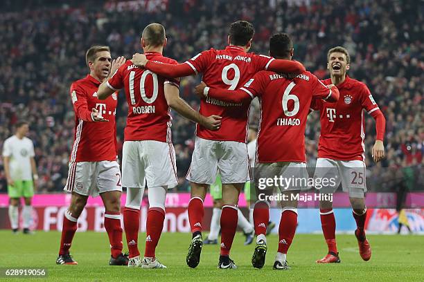 Robert Lewandowski of Muenchen celebrates his team's third goal with team mates during the Bundesliga match between Bayern Muenchen and VfL Wolfsburg...