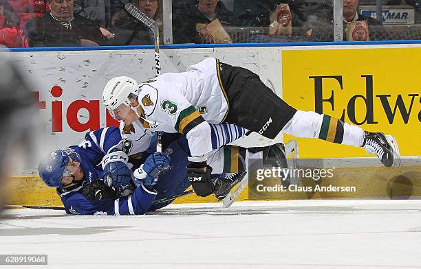 Jeremy Goodwin of the Mississauga Steelheads gets crushed by Nicolas Mattinen of the London Knights during an OHL game at Budweiser Gardens on...