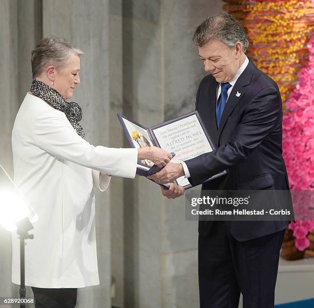 Colombian President, Juan Manuel Santos receives the Nobel Peace Prize from Berit Reiss-Andersen at the Nobel Peace Prize ceremony at Oslo City Town...