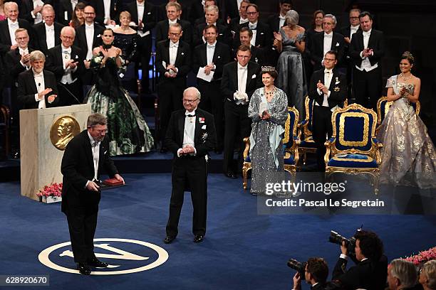 Professor J. Michael Kosterlitz, laureate of the Nobel Prize in Physics acknowledges applause after he received his Nobel Prize from King Carl XVI...