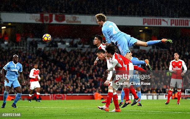 Peter Crouch of Stoke City heads towards goal during the Premier League match between Arsenal and Stoke City at the Emirates Stadium on December 10,...