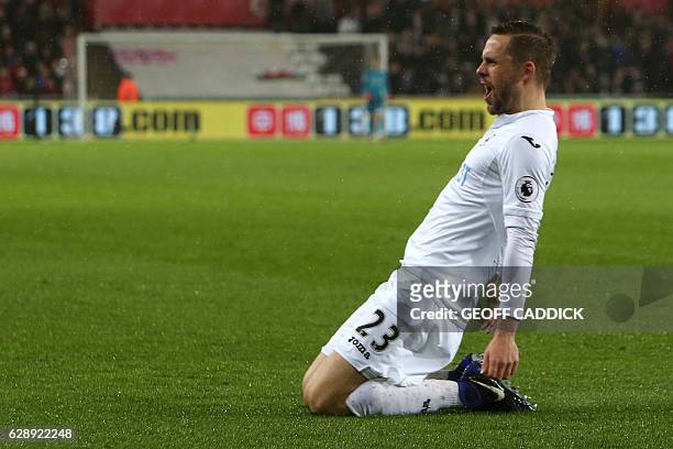 Swansea City's Icelandic midfielder Gylfi Sigurdsson celebrates after scoring the opening goal from the penalty spot during the English Premier...