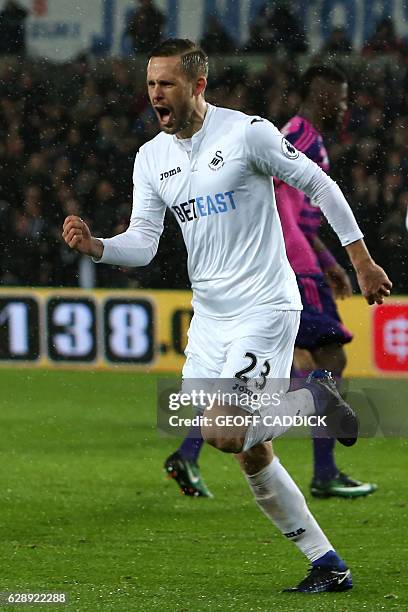 Swansea City's Icelandic midfielder Gylfi Sigurdsson celebrates after scoring the opening goal from the penalty spot during the English Premier...