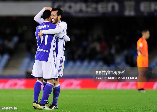 Real Sociedad's midfielder Juanmi is congratulated by teammate Mexican forward Carlos Vela after scoring his team's third goal during the Spanish...