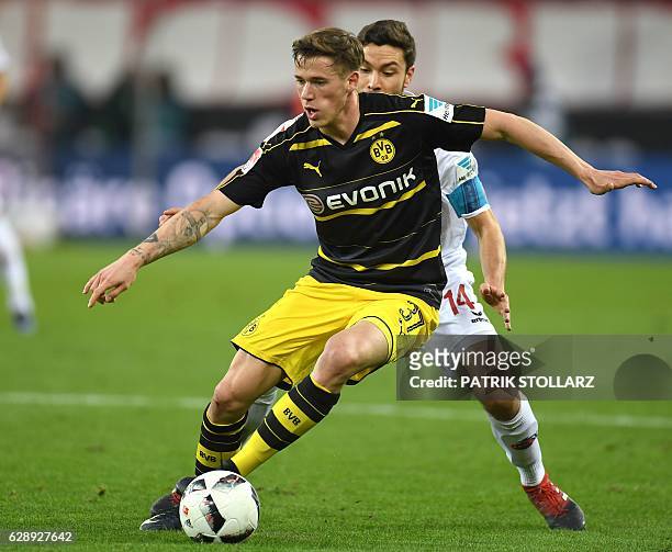 Dortmund's defender Erik Durm and Cologne's defender Jonas Hector vie for the ball during the German first division Bundesliga football match between...