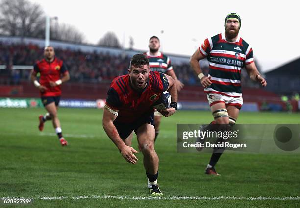 Jaco Taute of Munster dives in for a try during the European Champions Cup match between Munster and Leicester Tigers at Thomond Park on December 10,...