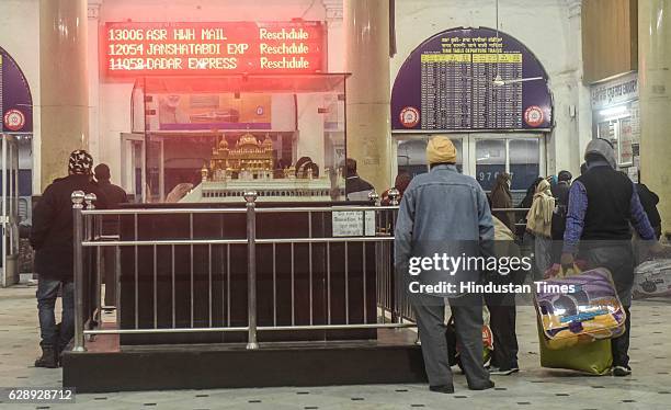 Passengers waiting at Amritsar Railway Station as scheduled trains running late due to foggy weather, on December 3, 2016 in Amritsar, India. Dense...