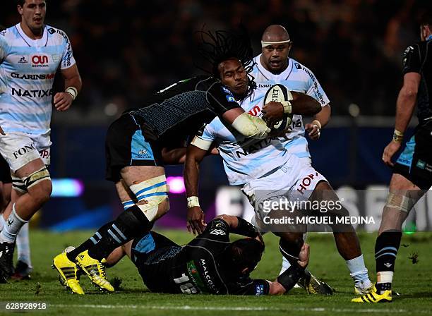 Racing Metro 92 center Albert Vulivuli is tackled by Glasgow warriors' Josh Strauss and Corey Flynn during the European Rugby champions cup match...