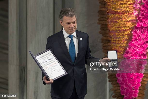 President Juan Manuel Santos of Colombia receives his Nobel Peace Prize Award during the Nobel Peace Prize ceremony at Oslo Town Hall on December 10,...
