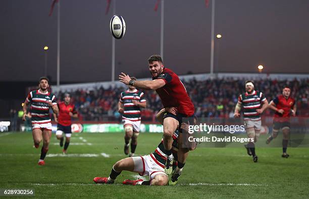 Jaco Taute of Munster is held back by George Worth which resulted in a penalty try during the European Champions Cup match between Munster and...