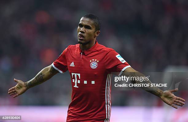 Bayern Munich's Brazilian midfielder Douglas Costa reacts after his goal during the German first division Bundesliga football match between FC Bayern...