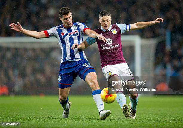 James Chester of Aston Villa ash challenged by Yanic Wildschut of Wigan Athletic during the Sky Bet Championship match between Aston Villa and Wigan...