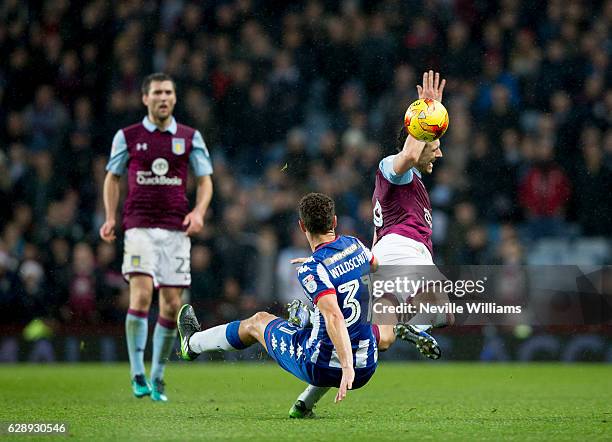 Tommy Elphick of Aston Villa ash challenged by Yanic Wildschut of Wigan Athletic during the Sky Bet Championship match between Aston Villa and Wigan...