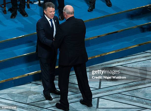 King Harald of Norway congratulates the Nobel Peace Prize winner President Juan Manuel Santos of Colombia, during the Nobel Peace Prize Ceremony at...