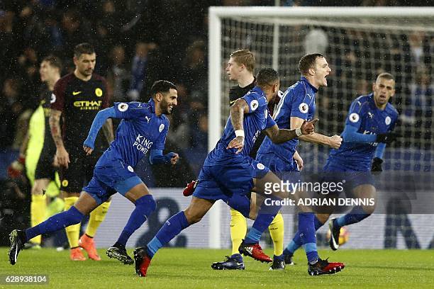 Leicester City's Welsh midfielder Andy King celebrates with teammates after scoring their second goal during the English Premier League football...