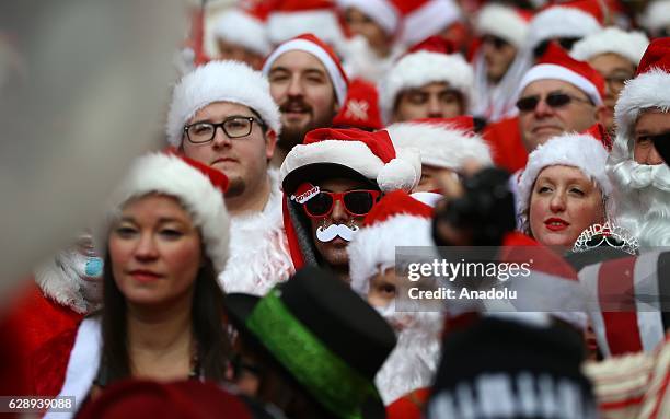 Revellers dressed up as Santa Claus take part in the annual Santacon festival at Times square in New York, United States on December 10, 2016....