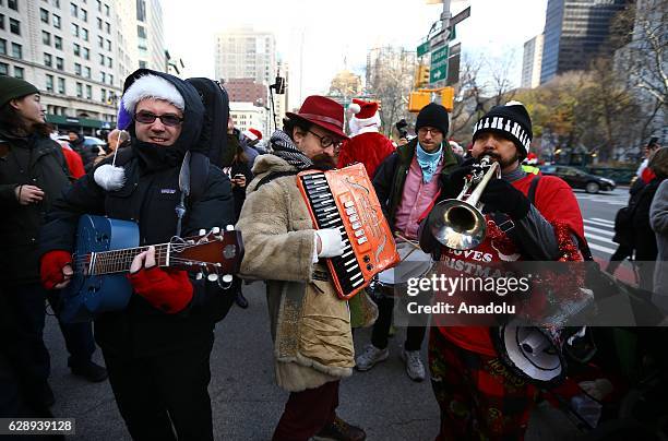 Revellers dressed up as Santa Claus take part in the annual Santacon festival at Times square in New York, United States on December 10, 2016....