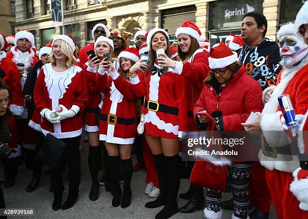 Revellers dressed up as Santa Claus take part in the annual Santacon festival at Times square in New York, United States on December 10, 2016....