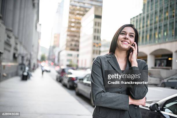 business woman calling on the phone - urban scene - montreal downtown stock pictures, royalty-free photos & images