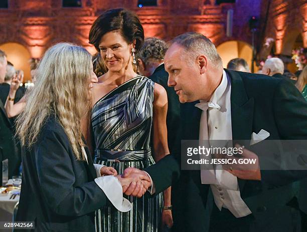 Singer Patti Smith talks to Swedish conservative leader Anna Kinberg Batra and Swedish left party leader Jonas Sjostedt at the 2016 Nobel prize award...