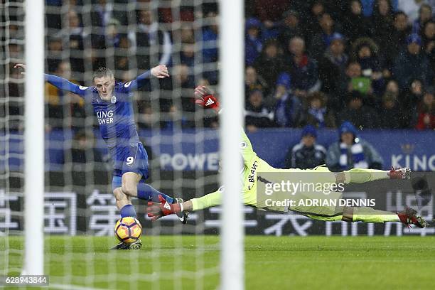 Leicester City's English striker Jamie Vardy takes the ball around Manchester City's Chilean goalkeeper Claudio Bravo on his way to scoring his third...