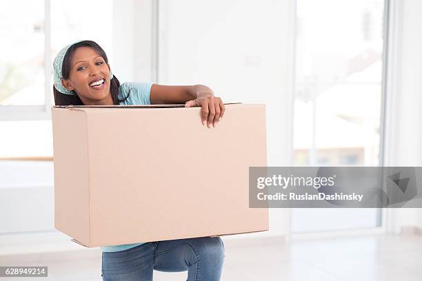 new home, new beginnings. - person lifting heavy object stock pictures, royalty-free photos & images
