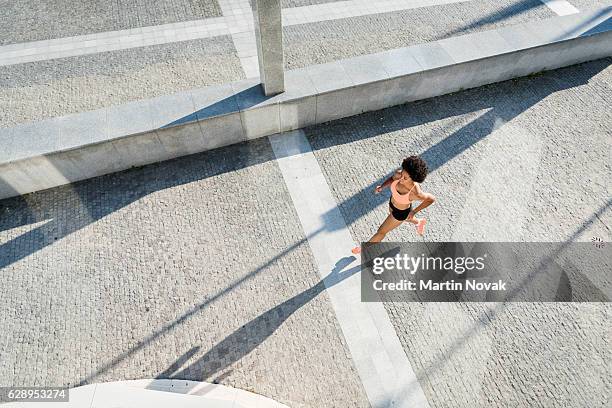 top view of a female athlete runner in action - person look up from above stock-fotos und bilder