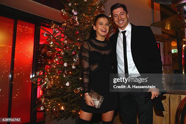 Robert Lewandowski of FC Bayern Muenchen poses with his wife Anna Stachurska as they arrive for the club's Christmas party at H'ugo's bar on December...