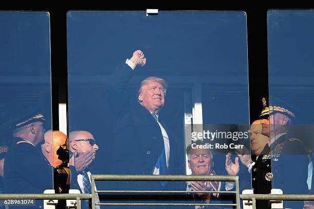 President-elect Donald Trump waves to the crowd while attending the Army Black Knights and Navy Midshipmen game at M&T Bank Stadium on December 10,...