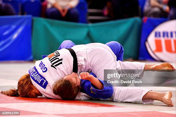 Lubjana Piovesana of Bishop Challoner JC throws and then holds Molly Game of Osaka JC to win their u63kg contest by an ippon during the 2016 British...